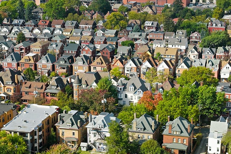 A Pittsburgh neighborhood seen from above, lots of different types of homes and trees